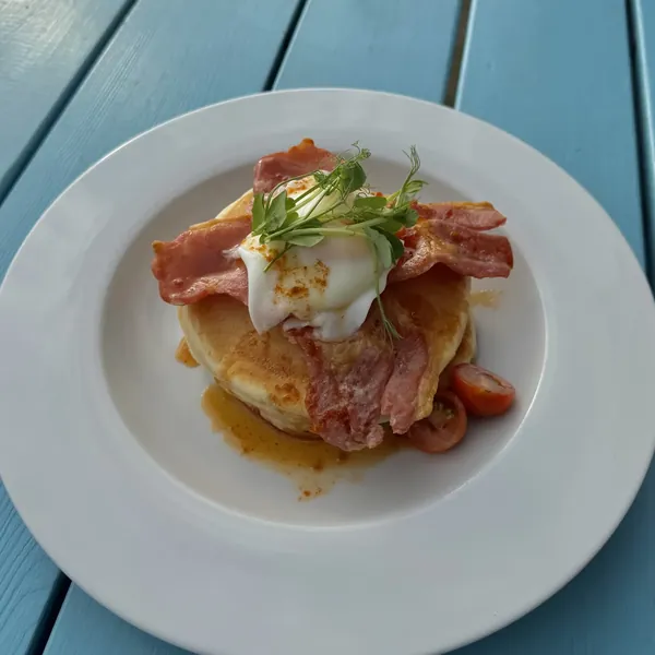 Buttermilk pancakes with crispy bacon, a poached egg and caramel chilli drizzle