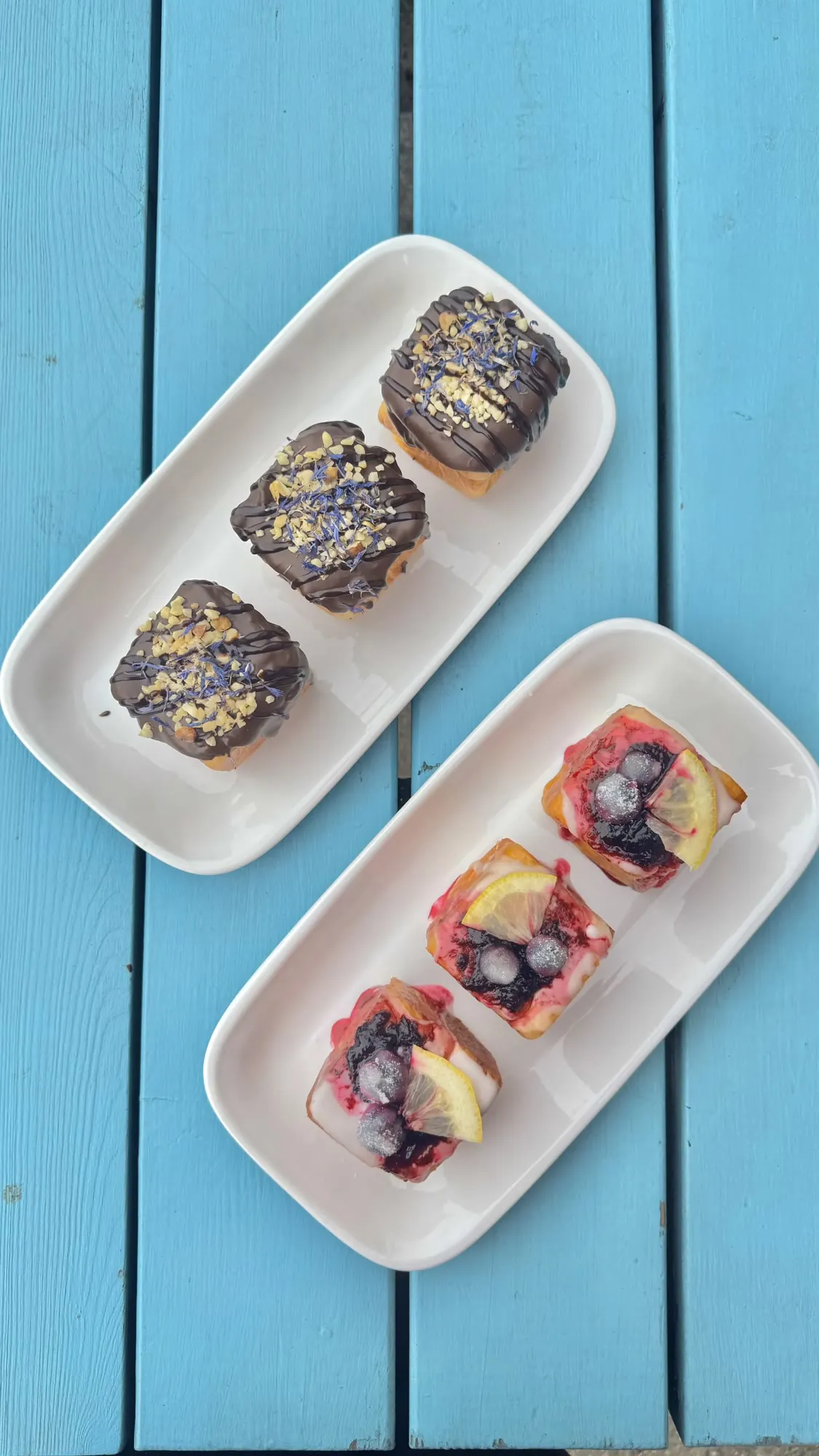 Chocolate and fruit traybakes on a blue table