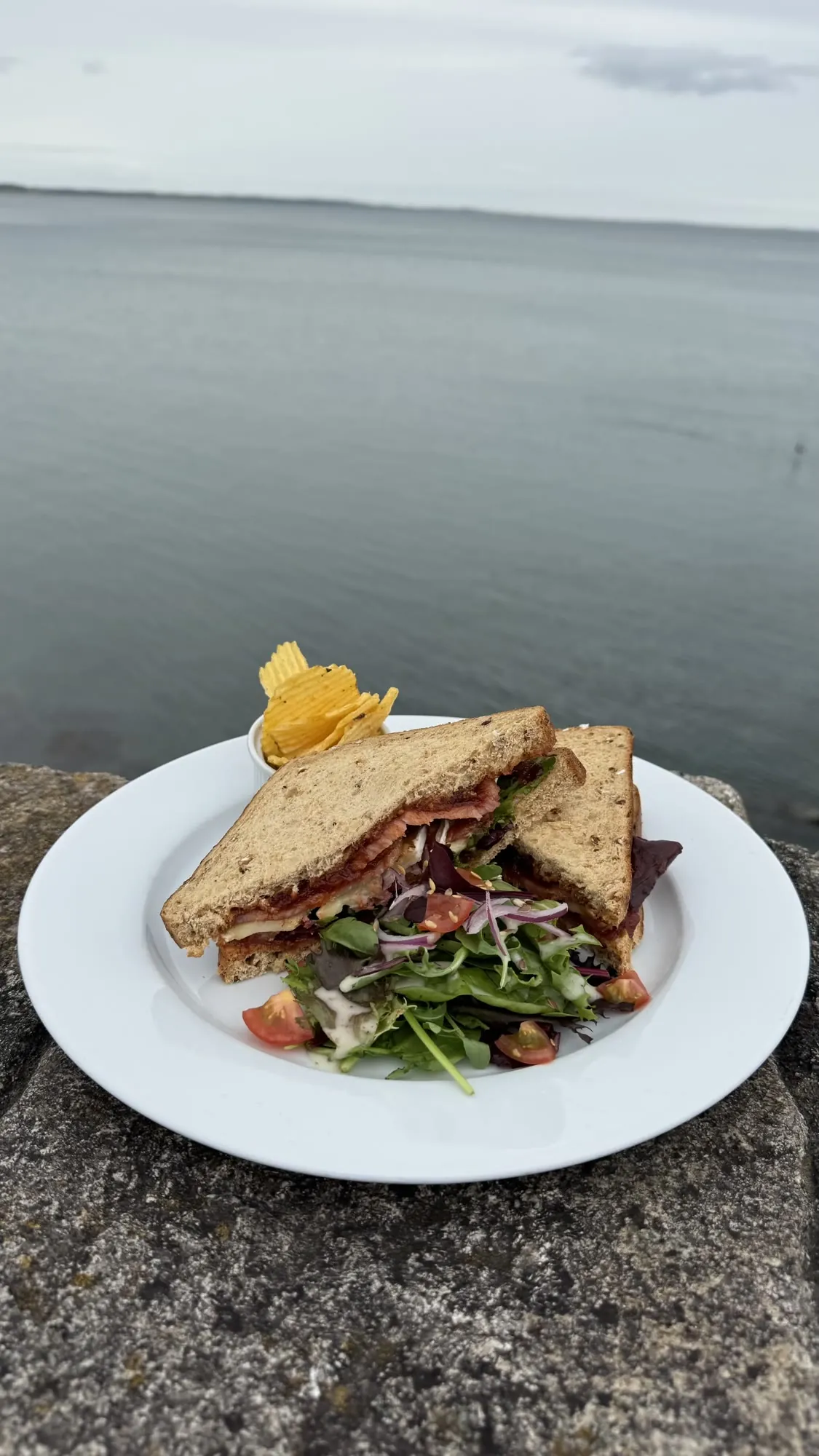 Club sandwich with salad by the sea