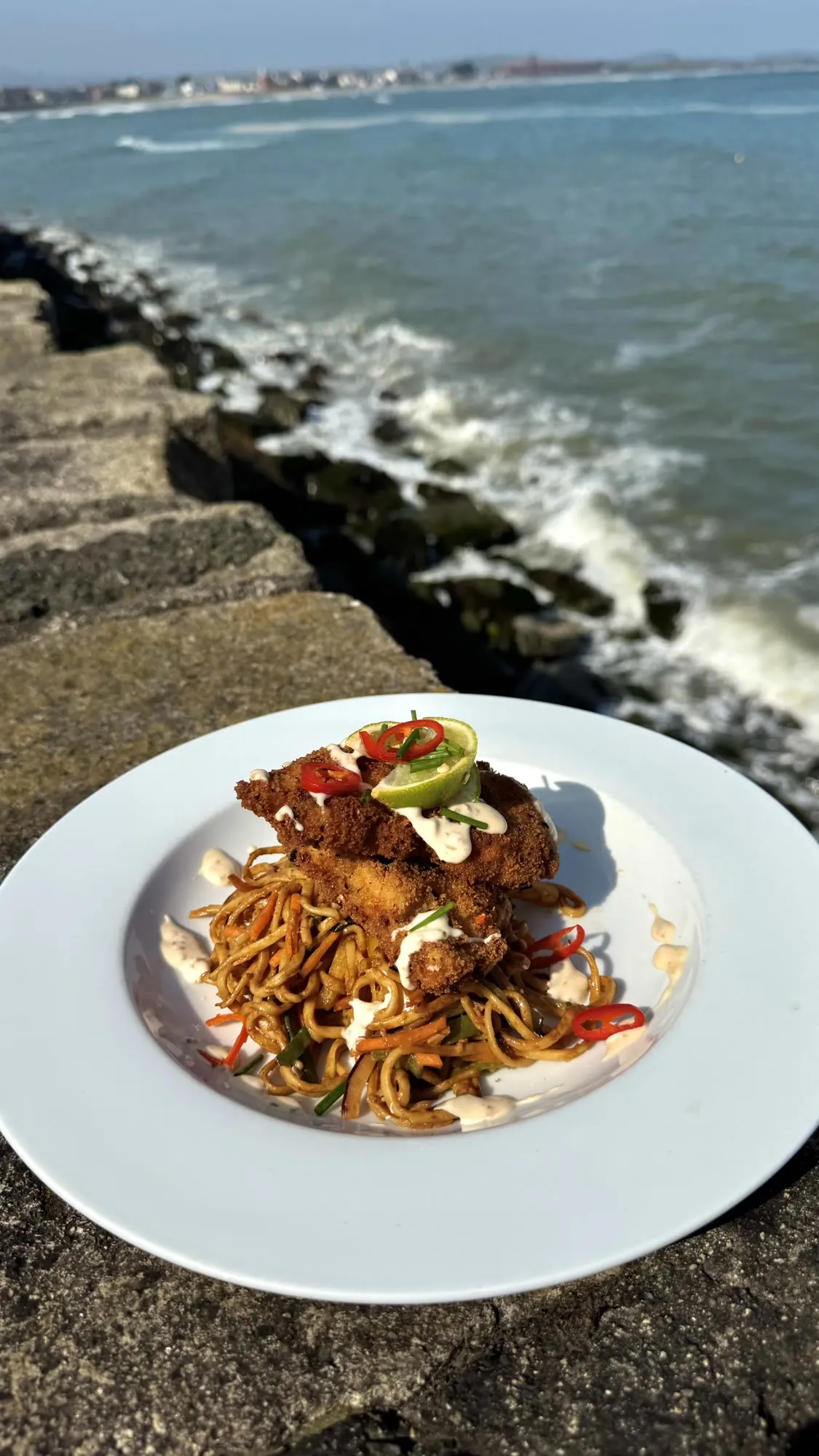 Harissa satay noodle salad with crispy chicken, by the sea